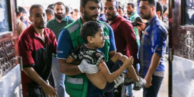 Hospitals in Gaza Face Shortage Of Medical Supplies 1 A medic carries a Palestinian child injured in Khan Younis in the southern Gaza Strip.