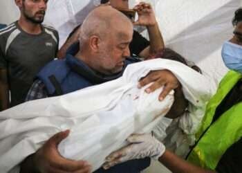 Wael Dahdouh mourns over the body of his seven-year-old daughter, who was killed along with his wife and son in an Israeli air raid in the Nuseirat refugee camp.