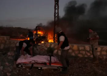 Journalist Killed In South Lebanon 4 Civil defence workers remove the body of a journalist killed by Israeli shelling at Alma al-Shaab, a village in southern Lebanon on the border with Israel.