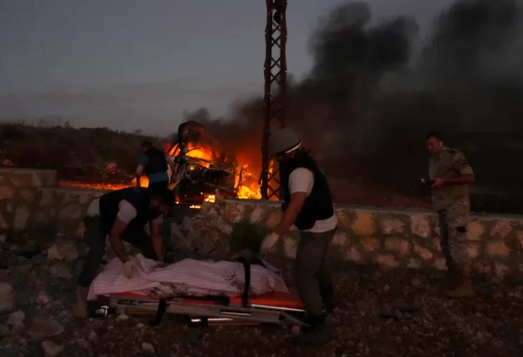 Journalist Killed In South Lebanon 1 Civil defence workers remove the body of a journalist killed by Israeli shelling at Alma al-Shaab, a village in southern Lebanon on the border with Israel.