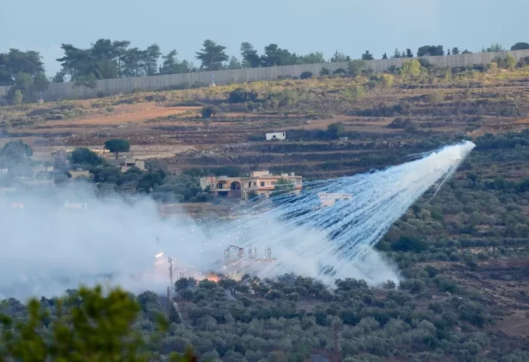 A shell fired by Israeli artillery explodes over a house in al-Bustan, a Lebanese border village with Israel, south Lebanon.