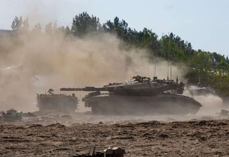 Thundering Words Spur Middle-East’s Raging Storm 1 Tanks move through the sand in Be’eri, Israel.