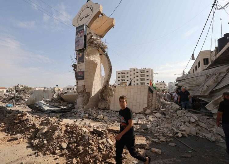 Palestinians survey the destruction following an Israeli military raid on the Jenin Palestinian refugee camp, in Jenin in the West Bank on October 30, 2023.