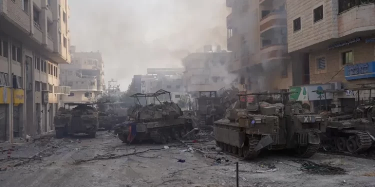 Israel Raids Al-Shifa Hospital 1 Israeli military vehicles manoeuvre in the Gaza Strip, as seen in a handout picture released by the Israeli army on November 13, 2023.