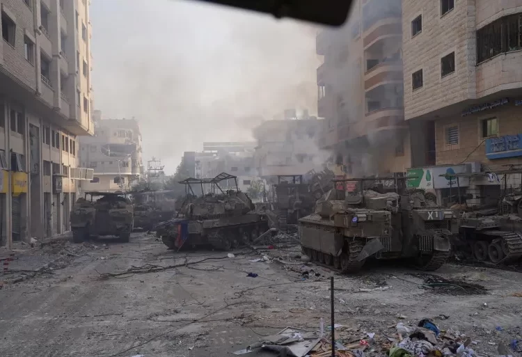 Israel Raids Al-Shifa Hospital 1 Israeli military vehicles manoeuvre in the Gaza Strip, as seen in a handout picture released by the Israeli army on November 13, 2023.