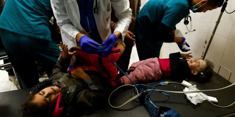 Palestinian children wounded in an Israeli strike are assisted at Nasser hospital in Khan Younis on Monday.