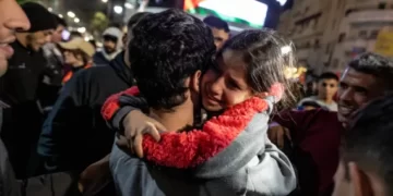 A girl hugs a newly released Palestinian prisoner in Ramallah in the occupied West Bank on Sunday.