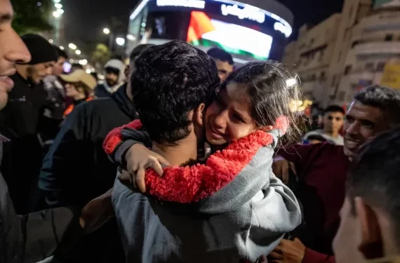 A girl hugs a newly released Palestinian prisoner in Ramallah in the occupied West Bank on Sunday.