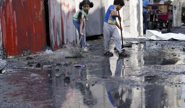 WFP Appeals For Expanded Access To Gaza 1 Palestinian kids mop outside their homes after the Israeli bombardment in the Maghazi refugee camp in the Gaza Strip on Sunday, Nov. 5, 2023.
