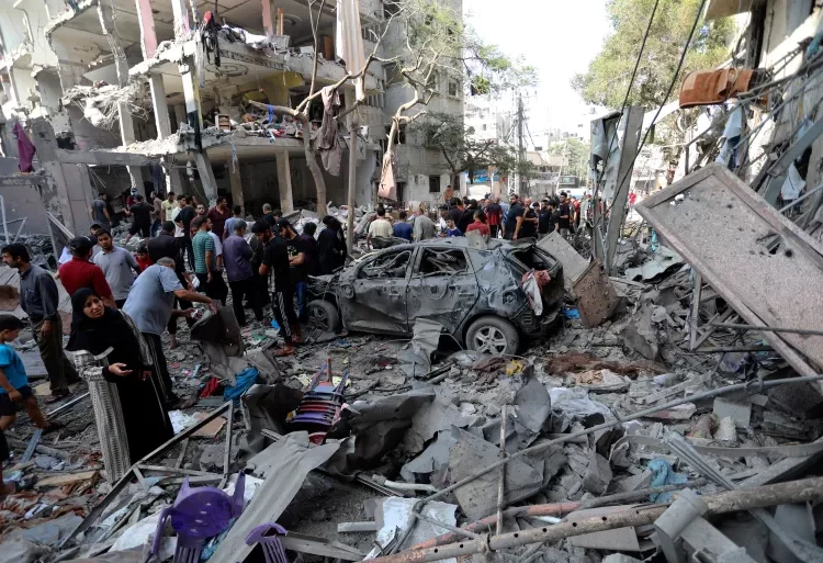 Bahrain Severs Economic Ties With Israel 1 Palestinians inspect the damage of buildings that were hit by Israeli airstrikes, in the Shati refugee camp, Gaza City.