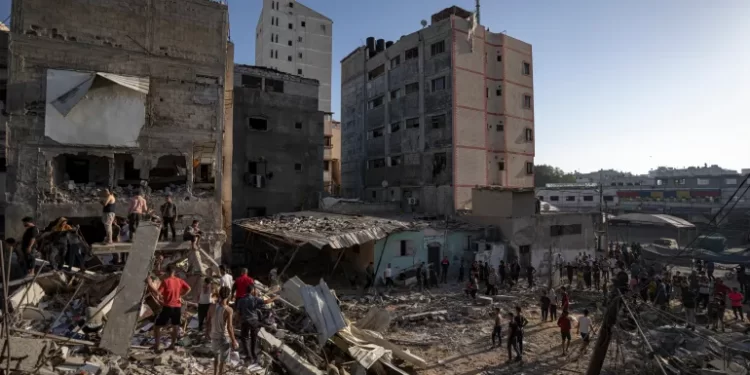 Saga Of Pain And Destruction Marks Milestone 1 Palestinians search amid the destruction after Israeli attacks in Khan Younis on the Gaza Strip.