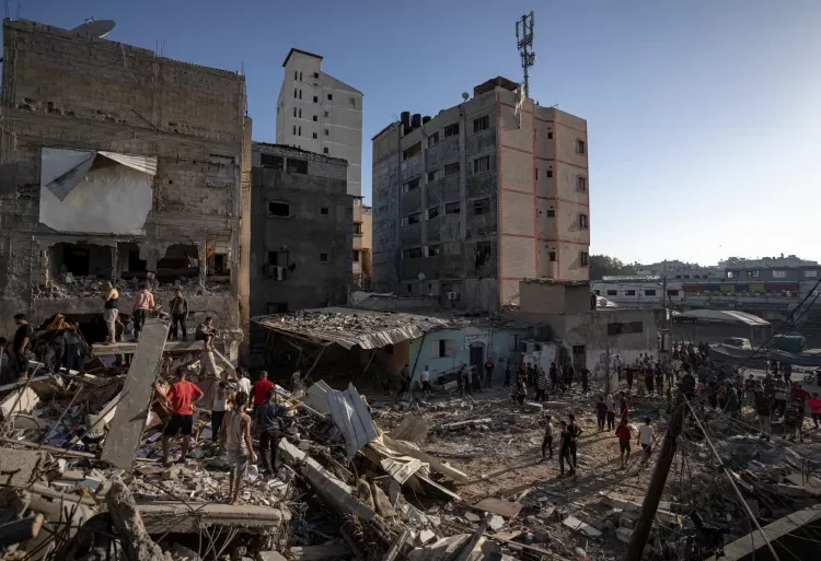 Saga Of Pain And Destruction Marks Milestone 1 Palestinians search amid the destruction after Israeli attacks in Khan Younis on the Gaza Strip.
