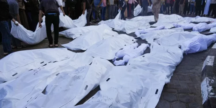Gazans Plunging Deeper Into Hell As Death Toll Reaches 10,022 1 Palestinians mourn relatives killed in the Israeli bombardment of the Gaza Strip in front of the morgue in Deir al Balah, Monday.