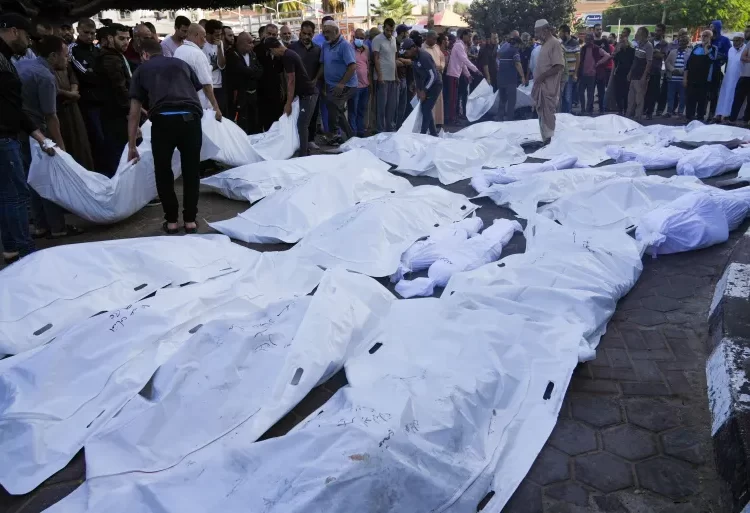 Palestinians mourn relatives killed in the Israeli bombardment of the Gaza Strip in front of the morgue in Deir al Balah, Monday.