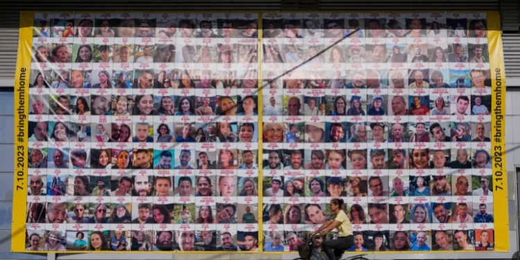 Time Running Out For Israeli Captives 1 A woman cycles next to a billboard calling for the return of hostages in Tel Aviv, Israel.