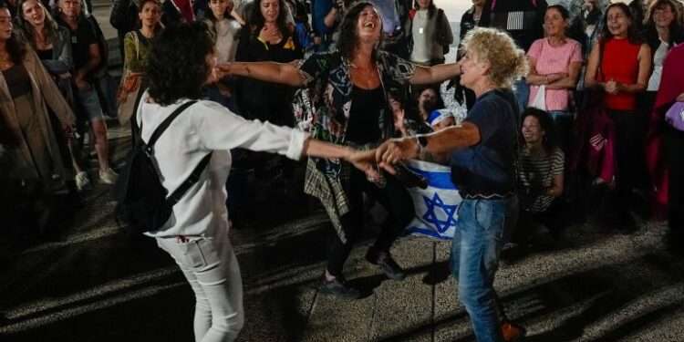 Israelis cheer news of the release of 13 captives.