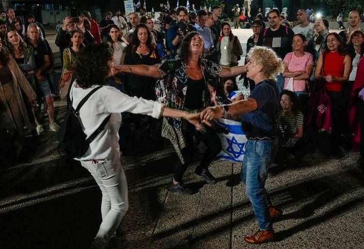 Israelis cheer news of the release of 13 captives.