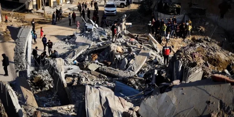 Palestinians gather at the site of an Israeli strike in Rafah, in the southern Gaza Strip.