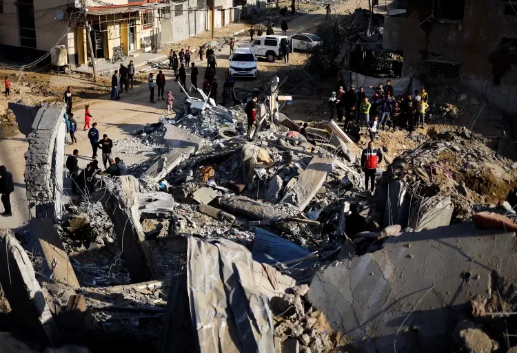 Israel Spits In The Face Of Truce 1 Palestinians gather at the site of an Israeli strike in Rafah, in the southern Gaza Strip.