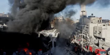 Fire burns and smoke billows at a destroyed house after an Israeli strike, in Khan Younis, Saturday.