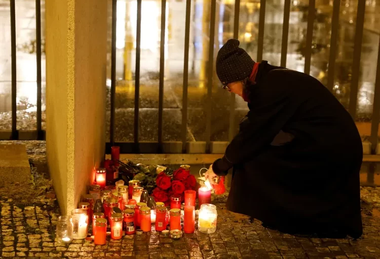 People began lighting candles outside the university for those killed in the shooting