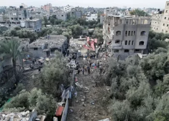 Palestinians gather at the site of Israeli strikes on houses at the Maghazi camp in the central Gaza Strip.
