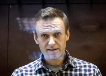 Russian Opposition leader, Alexei Navalny looks at photographers from inside a glass cage in a Moscow court in February 2021.