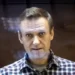 Russian Opposition leader, Alexei Navalny looks at photographers from inside a glass cage in a Moscow court in February 2021.