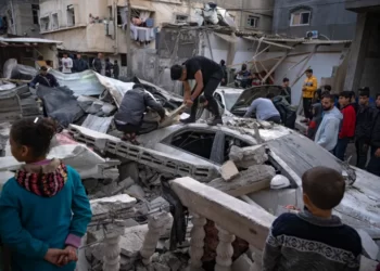 Palestinians inspect a house after it was hit by an Israeli bombardment on Rafah, southern Gaza Strip.