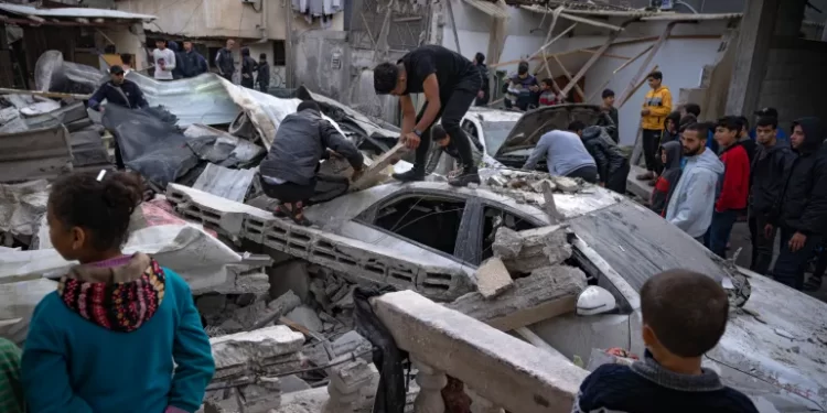 Palestinians inspect a house after it was hit by an Israeli bombardment on Rafah, southern Gaza Strip.