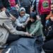 People mourn as they collect the bodies of Palestinians killed in an air strike in Khan Younis, Gaza.