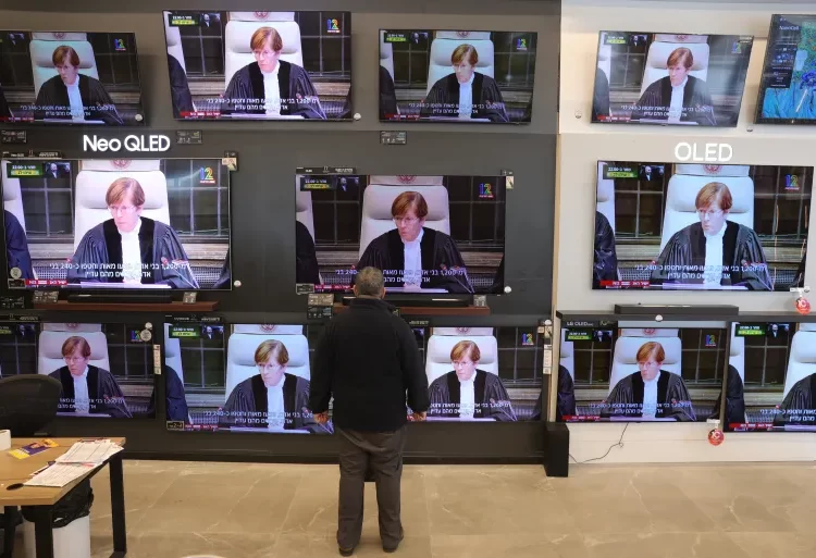 Israel Ordered To Take Steps To Prevent Acts Of Genocide In Gaza 1 Livestream from the International Court of Justice at a TV shop in Jerusalem.