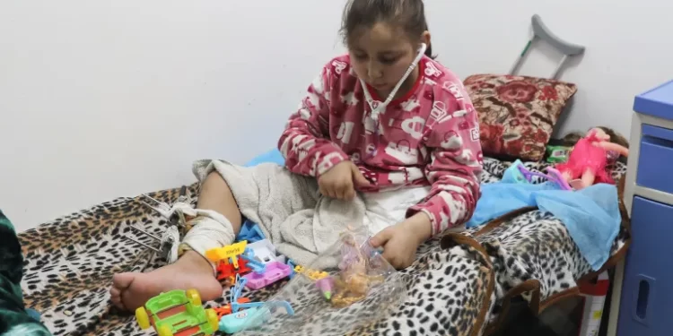 2023 Labelled As "Year Of Genocide" Against Palestinian Children 1 A Palestinian girl whose limb was amputated after being wounded in an Israeli strike receives treatment at the European Hospital in Rafah.