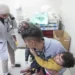 A Palestinian holds a child wounded in an Israeli strike at Nasser Hospital in Khan Younis, January 22, 2024.