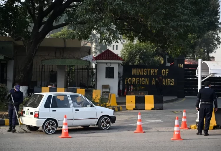 A Pakistani police officer checks a vehicle stand entering the Ministry of Foreign Affairs in Islamabad on January 18, 2024.