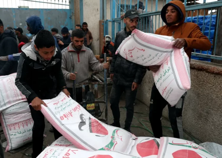 Norway Tranfers Funds To UNRWA 1 Palestinians carry bags of flour distributed by UNRWA in Rafah in the southern Gaza Strip on January 29, 2024.