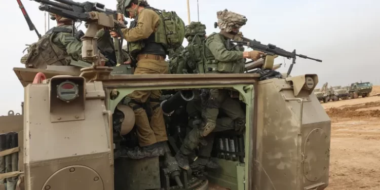 Israeli troops prepare weapons near Gaza.