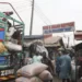 Workers offload grain from a truck at the MIle 12 Market in Lagos, Nigeria