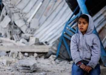 Palestinian child sits at the site of an Israeli strike on a house, amid the ongoing conflict between Israel and the Palestinian Islamist group Hamas, in Rafah in the southern Gaza Strip, February 7, 2024.