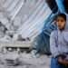 Palestinian child sits at the site of an Israeli strike on a house, amid the ongoing conflict between Israel and the Palestinian Islamist group Hamas, in Rafah in the southern Gaza Strip, February 7, 2024.