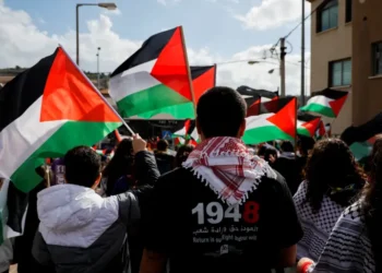 Israeli Arabs hold Palestinian flags as they take part in a Land Day commemoration in 2023.