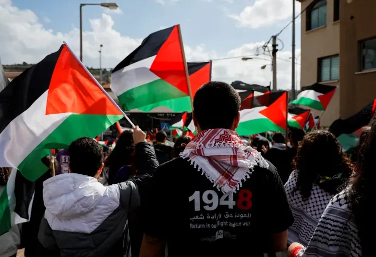 Israeli Arabs hold Palestinian flags as they take part in a Land Day commemoration in 2023.