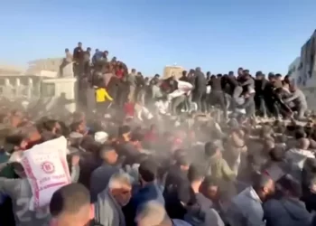 People rush towards an aid truck carrying bags of flour in Al Zaytun neighbourhood of Gaza City, in this still picture taken from a video, on Saturday.