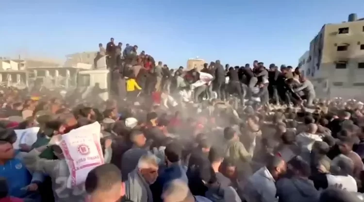 People rush towards an aid truck carrying bags of flour in Al Zaytun neighbourhood of Gaza City, in this still picture taken from a video, on Saturday.