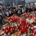 People gather at a makeshift memorial for the victims of a shooting attack set up outside the Crocus City Hall concert venue in the Moscow Region, Russia.