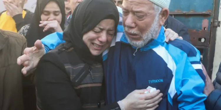 People mourn family members killed in Israeli strikes at al-Aqsa Hospital.