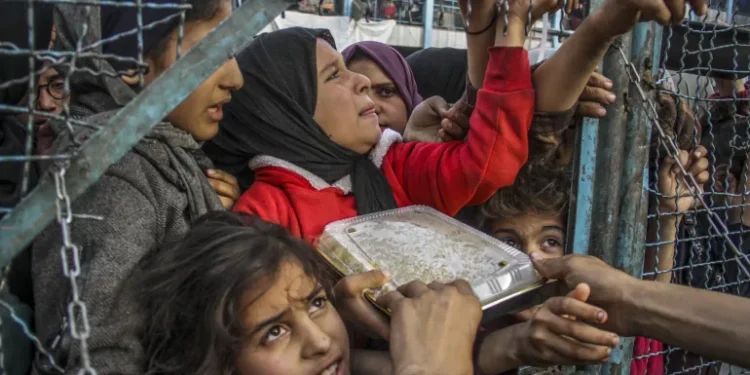 Gaza’s Condition Worsened By Israel’s Silent Weapon 1 A crowd of starving Palestinians wait to receive food in Jabalia refugee camp in northern Gaza on March 27, 2024.