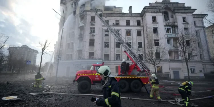 Firefighters work at the site of a building damaged after a Russian attack in Kyiv, Ukraine on Thursday, March 21, 2024.