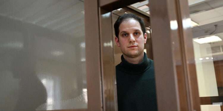 Calls For Gershkovich’s Release Made On Arrest Anniversary 1 Evan Gershkovich, arrested on espionage charges, looks out from inside a defendants' cage before a hearing to consider an appeal to his extended pre-trial detention, at the Moscow City Court in Moscow on Feb. 20, 2024.