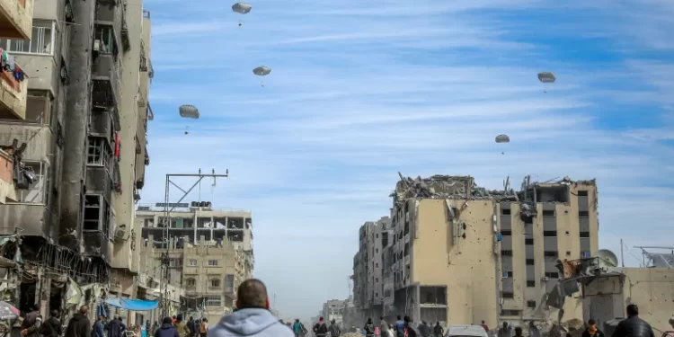 U.S Failing To Use Leverage To Assuage Gaza’s Woes 1 Palestinians run along a street as humanitarian aid is airdropped in Gaza City on Friday.